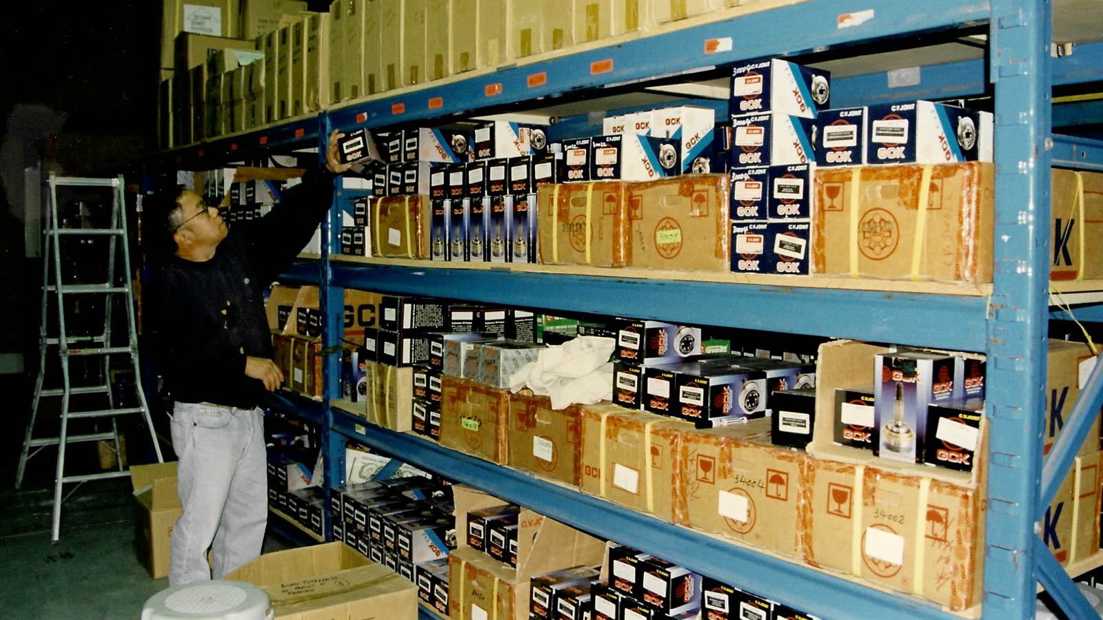 Soune stocking parts onto the rack in our first warehouse, CV joint boxes stacked to the ceiling