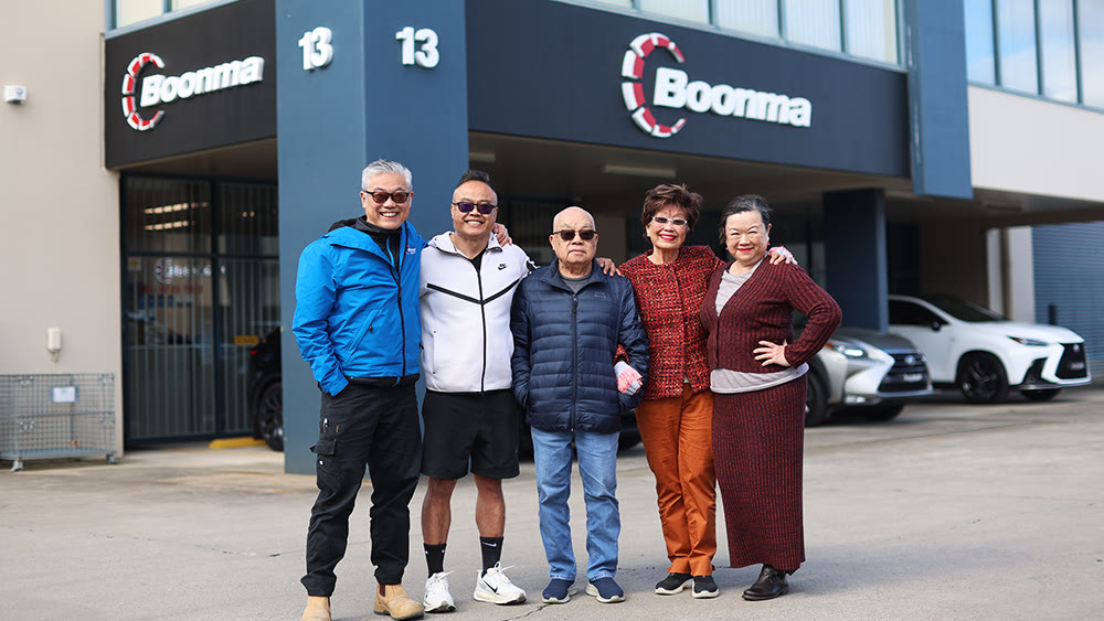 Boonma and Soune, the original founders and the next generation, Vanh, Sorn and Air, outside the current warehouse with our new logo
