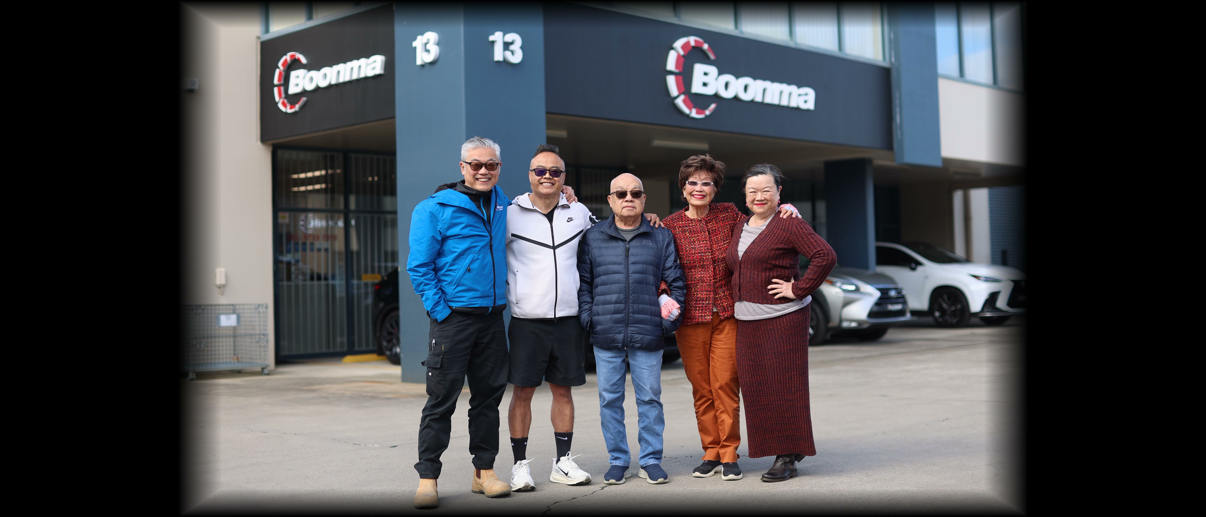 Boonma and Soune, the original founders and the next generation, Vanh, Sorn and Air, outside the current warehouse with our new logo